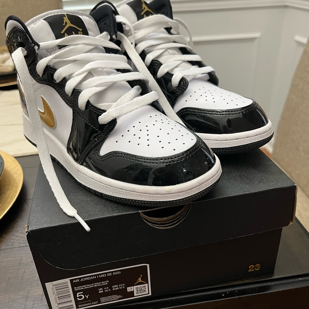 Air Jordan 1 Mid Black and Gold Sneakers